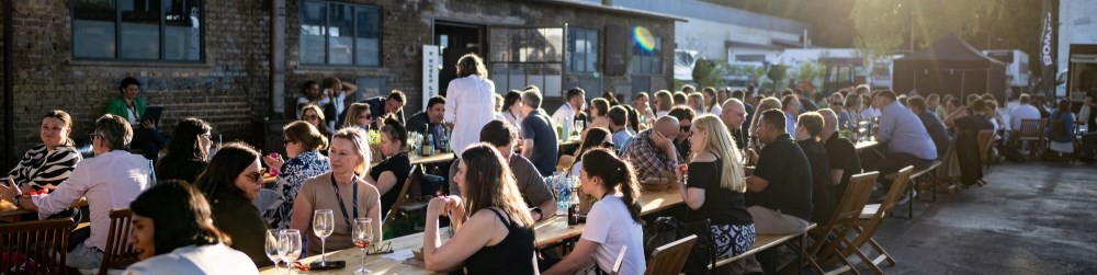 a group of people sitting at tables and networking