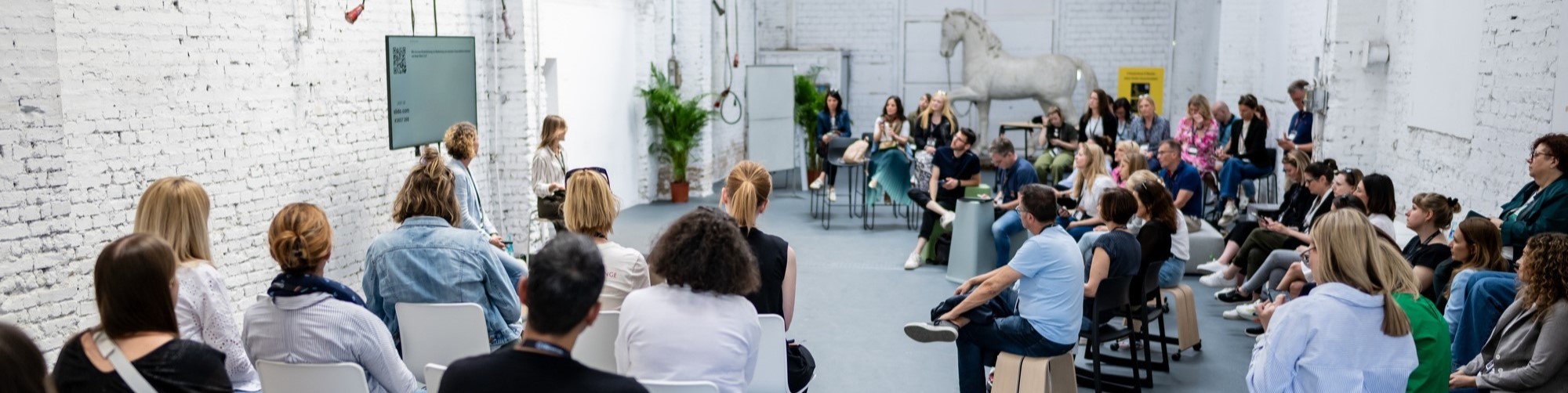 a group of people sitting at tables and networking